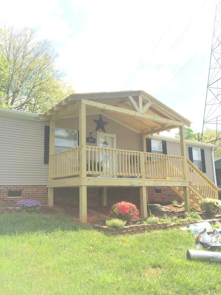 New gabled porch roof and deck railing added to a ranch home in Winthrop